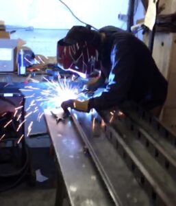 image of person in the process of welding metal