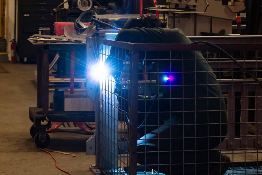 metal worker welding a cage